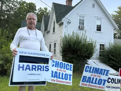 Voter Tom Chase displays a campaign sign with President Joe Biden's name cut out in Northwood, N.H., Sunday, July 21, 2024. Chase, 79, said he removed Biden's name last week and was relieved and delighted that the president withdrew from his 2024 campaign and endorsed Vice President Kamala Harris. (AP Photo/Holly Ramer)