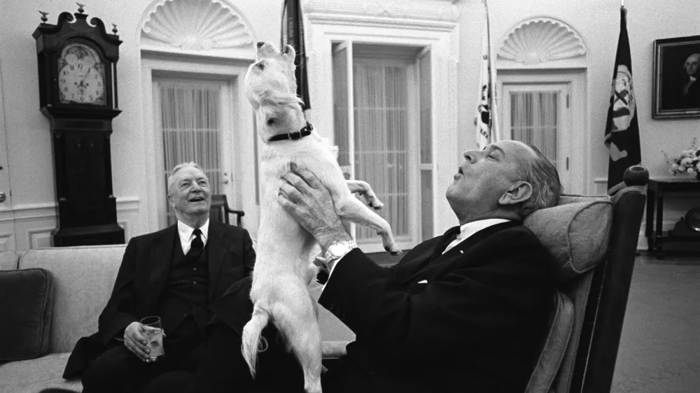 President Lyndon B. Johnson sings with his dog Yuki as Ambassador David Bruce looks on in the Oval Office of the White House, Washington, D.C. February 6, 1968. Yoichi Okamoto/LBJ Library/Handout via REUTERS THIS IMAGE HAS BEEN SUPPLIED BY A THIRD PARTY