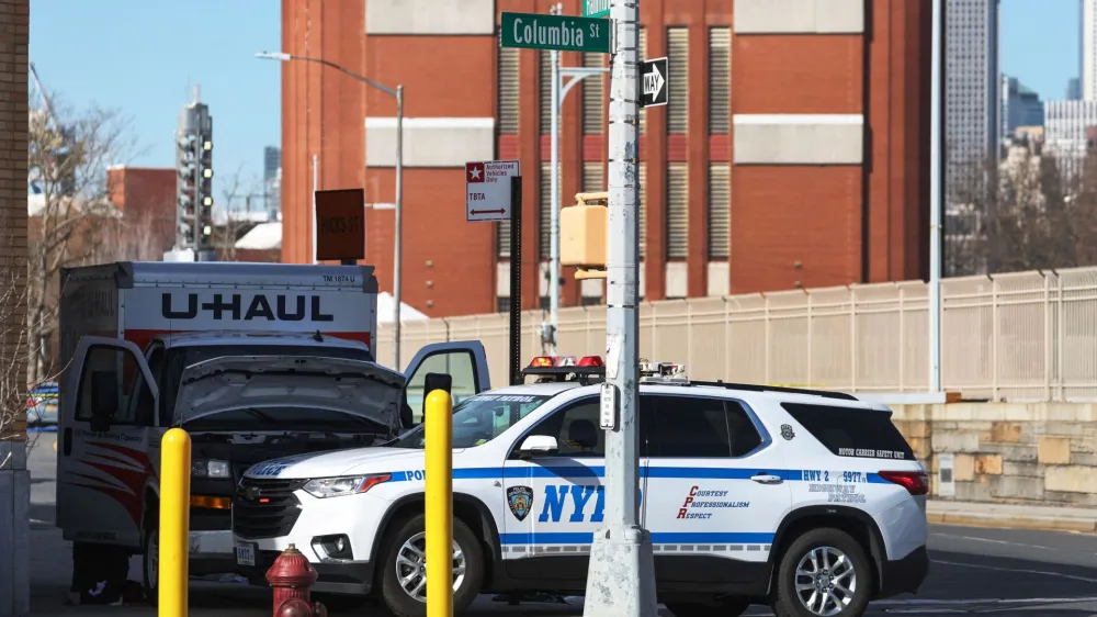 A New York Police Department vehicle blocks a U-Haul rental vehicle, where according to media reports, a man struck multiple people and the NYPD took the driver into custody, near the Battery tunnel in the Brooklyn borough of New York City, U.S., February 13, 2023. REUTERS/Shannon Stapleton