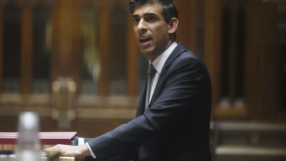 In this handout photo provided by UK Parliament, Britain's Chancellor of the Exchequer Rishi Sunak delivering his Spring Statement in the House of Commons in the House of Commons in London, Wednesday, March 23, 2022. Sunak announced a package of tax cuts and support payments that fell far short of what consumer advocates had demanded to shield working families from the soaring cost of living, triggering criticism that he doesn't understand the scale of the crisis. (Jessica Taylor/UK Parliament via AP)