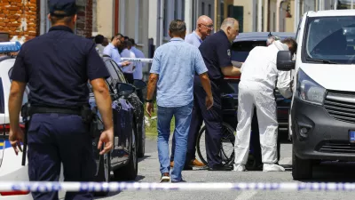 Police and forensics gather near the crime scene in Daruvar, central Croatia, Monday, July 22, 2024. An armed assailant entered a care home for older people in central Croatia Monday and opened fire, killing five people and wounding several others, authorities and media reports said. (Zeljko Puhovski/Cropix via AP)