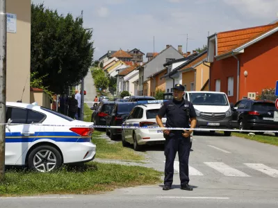 A police officer stands near the crime scene in Daruvar, central Croatia, Monday, July 22, 2024. An armed assailant entered a care home for older people in central Croatia Monday and opened fire, killing five people and wounding several others, authorities and media reports said. (Zeljko Puhovski/Cropix via AP)