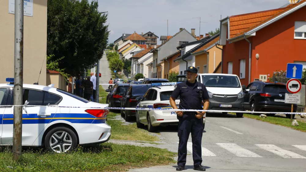 A police officer stands near the crime scene in Daruvar, central Croatia, Monday, July 22, 2024. An armed assailant entered a care home for older people in central Croatia Monday and opened fire, killing five people and wounding several others, authorities and media reports said. (Zeljko Puhovski/Cropix via AP)