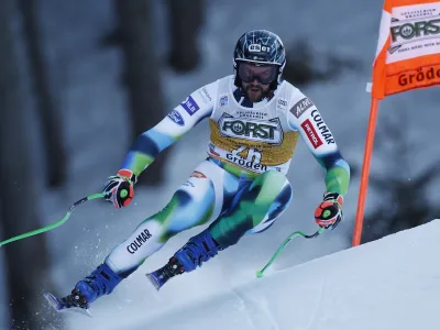 Slovenia's Bostjan Kline speeds down the course during an alpine ski, men's World Cup downhill race, in Val Gardena, Italy, Saturday, Dec.18, 2021. (AP Photo/Gabriele Facciotti)