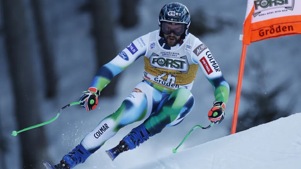 Slovenia's Bostjan Kline speeds down the course during an alpine ski, men's World Cup downhill race, in Val Gardena, Italy, Saturday, Dec.18, 2021. (AP Photo/Gabriele Facciotti)