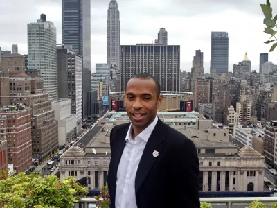 French soccer star Thierry Henry gets a rooftop view of New York after an interview, Thursday, July 15, 2010. Henry is retiring from the French national team. The 32-year-old forward announced his decision during an interview Thursday at the offices of The Associated Press before a news conference to discuss his signing with Major League Soccer's New York Red Bulls.