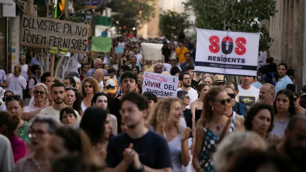 People take part in a protest against mass tourism in Palma de Mallorca, Spain, July 21, 2024. REUTERS/Stringer