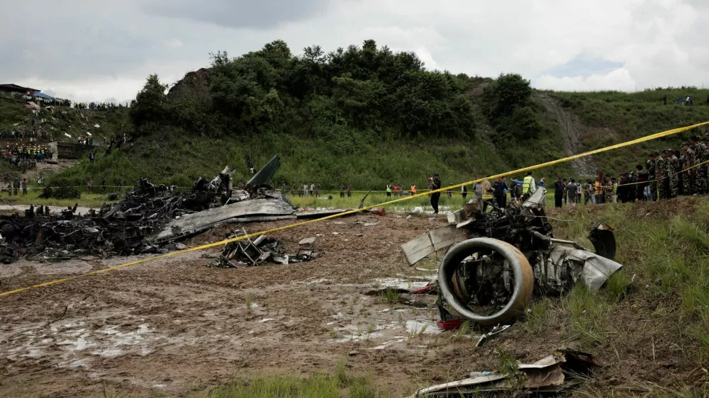 Emergency personnel work at the accident site of a Saurya Airlines plane that caught fire after skidding off the runway while taking off at Tribhuvan International Airport, in Kathmandu, Nepal July 24, 2024.  REUTERS/Navesh Chitrakar