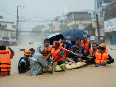 Rescuers assist residents on a boat as they wade through a flooded road following heavy rains brought by Typhoon Gaemi, in Marikina City, Metro Manila, Philippines, July 24, 2024. REUTERS/Lisa Marie David