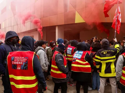 Striking workers stand in front of a power control center as they cut power to the large sports arena Stade de France and the Olympic village in the northern suburb of Saint-Ouen, near Paris, March 9, 2023. REUTERS/Noemie Olive