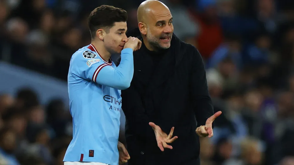 Soccer Football - Champions League - Round of 16 - Second Leg - Manchester City v RB Leipzig - Etihad Stadium, Manchester, Britain - March 14, 2023 Manchester City manager Pep Guardiola with Julian Alvarez before he comes on as a substitute REUTERS/Molly Darlington