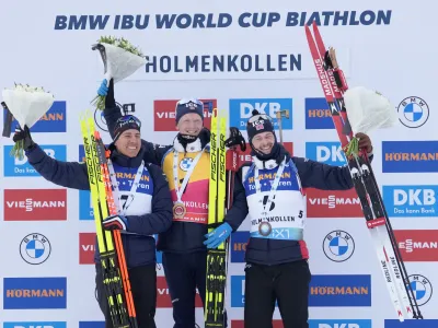 18 March 2023, Norway, Oslo: France's second-placed Quentin Fillon Maillet, Norway's first-placed Johannes Thingnes Boe, and Norway's third-placed Sturla Holm Laegreid celebrate on the podium after winning the men's pursuit race during the International Biathlon Union (IBU) World Cup in Holmenkollen. Photo: Javad Parsa/NTB/dpa