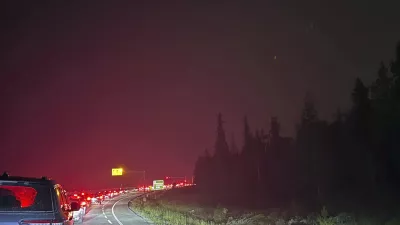 This photo provided by Carolyn Campbell shows cars clogging the highway as people evacuate because of wildfires early Tuesday, July 23, 2024, in Jasper, Alberta. Multiple wildfires in Canada's Jasper National Park have flared up, forcing all park visitors along with the 4,700 residents of the Jasper townsite to flee. (Carolyn Campbell/The Canadian Press via AP)