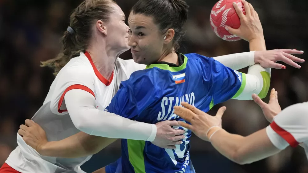 Tjasa Stanko, of Slovenia, tries to shoot the ball against Denmark during the preliminary handball matches at the 2024 Summer Olympics, Thursday, July 25, 2024, in Paris, France. (AP Photo/Aaron Favila)