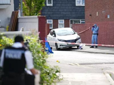 24 July 2024, United Kingdom, London: A forensic officer at the scene in Stellman Close in Hackney, where a 15-year-old boy died after being stabbed at about 4pm on Tuesday. A 15-year-old boy has been arrested on suspicion of murdering the teenager. Photo: -/PA Wire/dpa