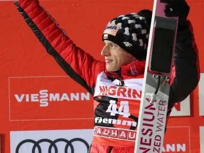 ﻿Second placed Dawid Kubacki of Poland celebrates on the podium after the men's HS135 ski jumping competition in Val di Fiemme, Italy, Saturday, Jan. 12, 2019. (Andrea Solero/ANSA via AP)