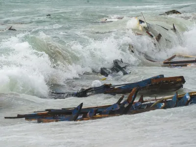 The wreckage from a capsized boat washes ashore at a beach near Cutro, southern Italy, Sunday, Feb. 26, 2023. Rescue officials say an undetermined number of migrants have died and dozens have been rescued after their boat broke apart off southern Italy. (Antonino Durso/LaPresse via AP)