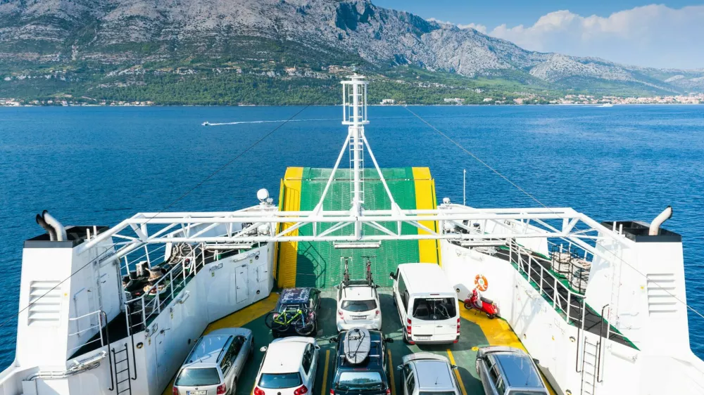 FB8T56 Cars on the ferry from the mainland Peljesac Peninsula to the Island of Korcula, Croatia, Europe.