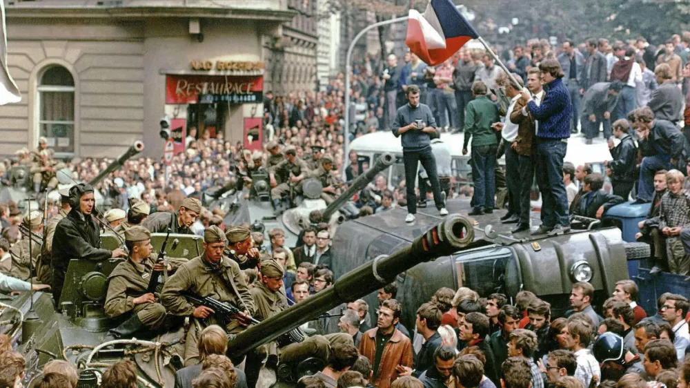 Prague residents surround Soviet tanks in front of the Czechoslovak Radio station building in central Prague during the first day of Soviet-led invasion to then Czechoslovakia August 21, 1968. Vera Machutova woke one August night in 1968 to the thunder of Soviet tanks surging through this Czech city on the East German frontier. Forty years later, with the Czech Republic now a democracy within NATO and the European Union, Machutova is troubled by the conflict in Georgia, whose army was routed last week by Russian forces that pushed deep inside its territory. The banner reads, "Entry forbidden to unauthorized personnel". Picture taken August 21, 1968. To match feature CZECH-RUSSIA/INVASION   REUTERS/Libor Hajsky (CZECH REPUBLIC)