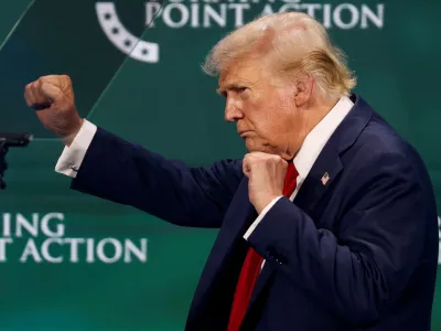 Republican presidential nominee and former U.S. President Donald Trump gestures on the stage at Turning Point Action's The Believers Summit 2024 in West Palm Beach, Florida, U.S., July 26, 2024. REUTERS/Marco Bello   TPX IMAGES OF THE DAY