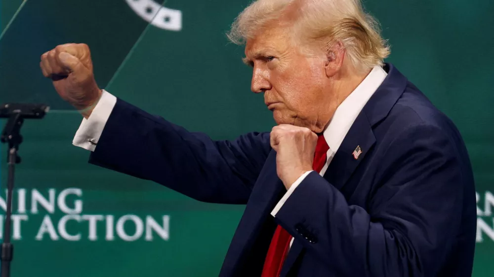 Republican presidential nominee and former U.S. President Donald Trump gestures on the stage at Turning Point Action's The Believers Summit 2024 in West Palm Beach, Florida, U.S., July 26, 2024. REUTERS/Marco Bello   TPX IMAGES OF THE DAY