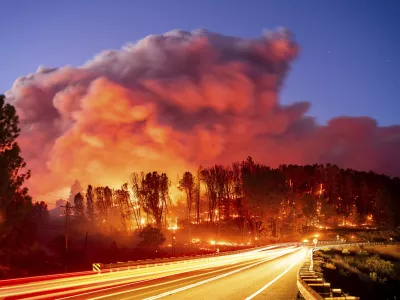 Seen in a long exposure photograph, the Park Fire burns along Highway 32 in the Forest Ranch community of Butte County, Calif., on Thursday, July 25, 2024. (AP Photo/Noah Berger)