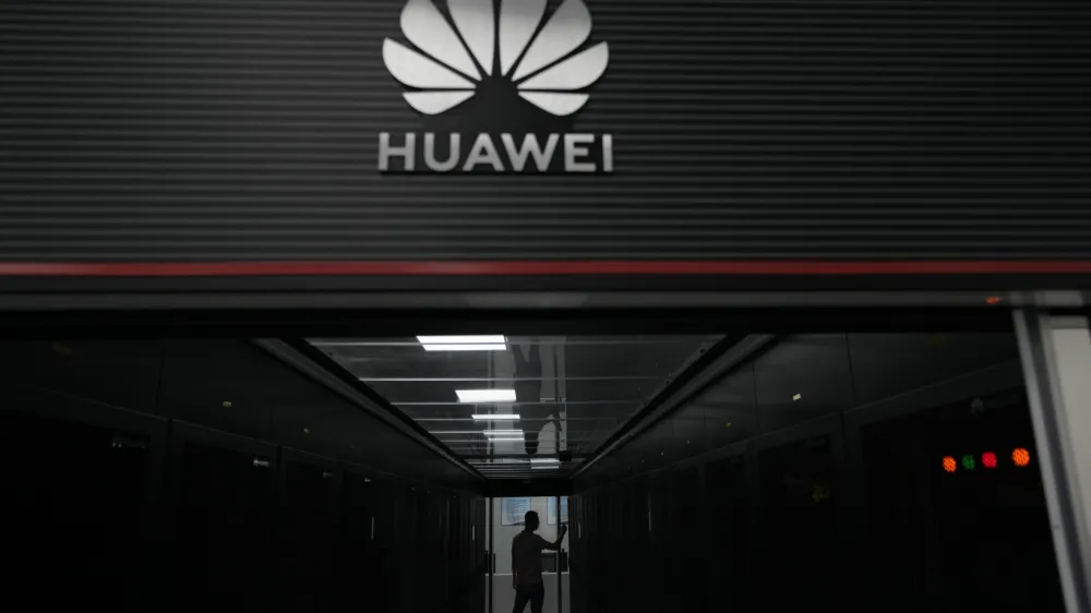 A technician stands at the entrance to a Huawei 5G data server center at the Guangdong Second Provincial General Hospital in Guangzhou, in southern China's Guangdong province on Sept. 26, 2021. The U.S. is banning the sale of communications equipment made by Chinese companies Huawei and ZTE and restricting the use of some China-made video surveillance systems, citing an "unacceptable risk" to national security. The 5-member Federal Communications Commission said Friday, Nov. 25, 2022 it has voted unanimously to adopt new rules that will block the importation or sale of certain technology products that pose security risks. (AP Photo/Ng Han Guan)