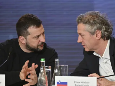 In this photo provided by the Ukrainian Presidential Press Office, Ukrainian President Volodymyr Zelenskyy, left, speaks to Slovenian Prime Minister Robert Golob during the Bucha Summit in Kyiv, Ukraine, Friday, March 31, 2023. (Ukrainian Presidential Press Office via AP)