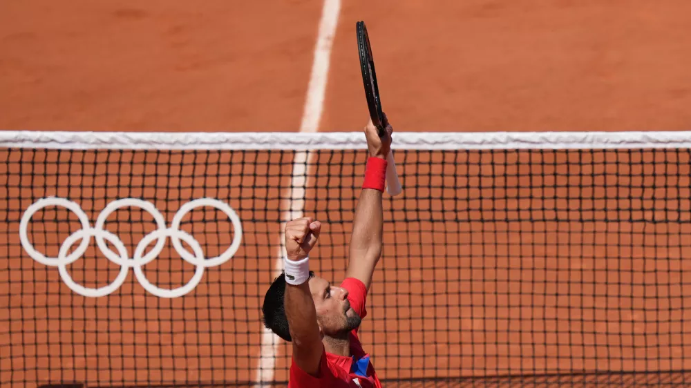 29 July 2024, France, Paris: Serbian tennis player Novak Djokovic celebrates after defeating Spain's Rafael Nadal in their men's singles second tennis match of the Paris 2024 Olympic Games. Photo: Marcus Brandt/dpa