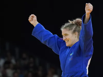 Slovenia's Andreja Leski celebrates after defeating Mexico's Prisca Awiti Alcaraz during their women -63 kg final match in team judo competition at Champ-de-Mars Arena during the 2024 Summer Olympics, Tuesday, July 30, 2024, in Paris, France. (AP Photo/Eugene Hoshiko)