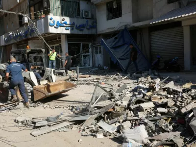 Municipal police members remove the rubble at a damaged site the day after an Israeli strike, in Beirut's southern suburbs, Lebanon July 31, 2024. REUTERS/Mohamed Azakir