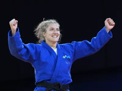 Slovenia's Andreja Leski celebrates after defeating Mexico's Prisca Awiti Alcaraz during their women -63 kg final match in team judo competition at Champ-de-Mars Arena during the 2024 Summer Olympics, Tuesday, July 30, 2024, in Paris, France. (AP Photo/Eugene Hoshiko)