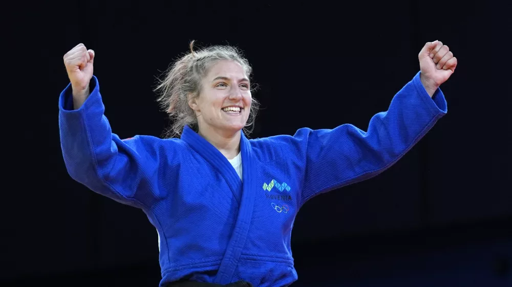 Slovenia's Andreja Leski celebrates after defeating Mexico's Prisca Awiti Alcaraz during their women -63 kg final match in team judo competition at Champ-de-Mars Arena during the 2024 Summer Olympics, Tuesday, July 30, 2024, in Paris, France. (AP Photo/Eugene Hoshiko)