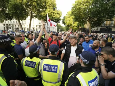 People attend the 'Enough is Enough' protest in Whitehall, London, Wednesday July 31, 2024, following the fatal stabbing of three children at a Taylor Swift-themed holiday club on Monday in Southport. (Jordan Pettitt/PA via AP)