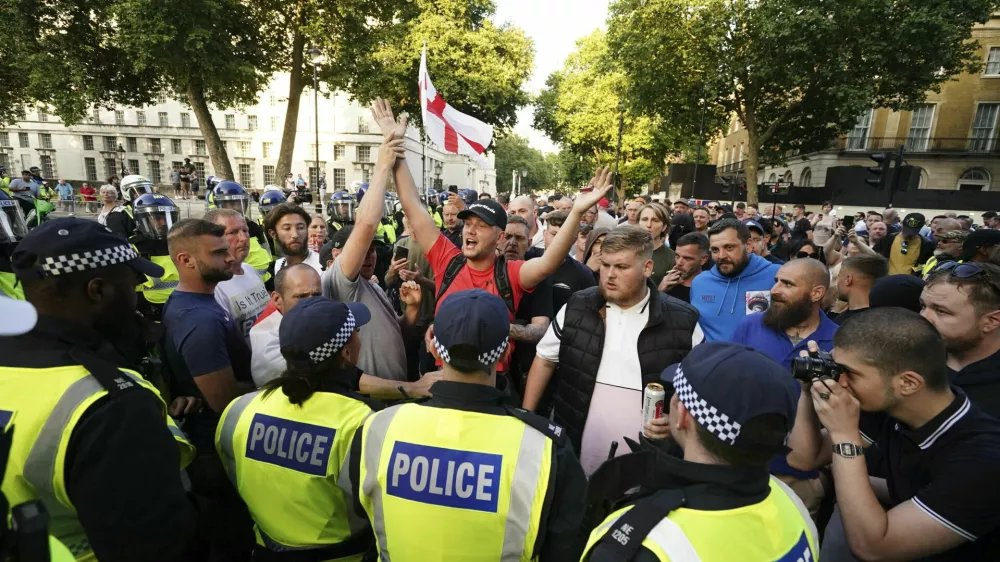 People attend the 'Enough is Enough' protest in Whitehall, London, Wednesday July 31, 2024, following the fatal stabbing of three children at a Taylor Swift-themed holiday club on Monday in Southport. (Jordan Pettitt/PA via AP)