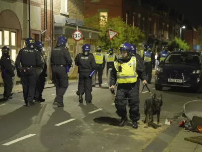 Police officers are deployed on the streets of Hartlepool, England, following a violent protest in the wake of the killing of three girls who were fatally stabbed in northwest England, Wednesday, July 31, 2024. (Owen Humphreys/PA via AP)