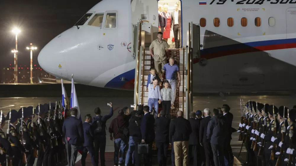 Russian President Vladimir Putin, center back to a camera, greets released Russian prisoners upon their arrival at the Vnukovo government airport outside Moscow, Russia, on Thursday, Aug. 1, 2024. The United States and Russia have made their biggest prisoner swap in post-Soviet history. (Gavriil Grigorov/Sputnik, Kremlin Pool Photo via AP)