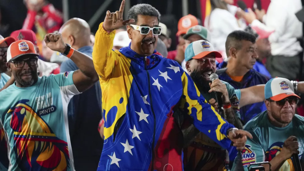 President Nicolas Maduro dances outside the Miraflores presidential palace after electoral authorities declared him the winner of the presidential election in Caracas, Venezuela, Monday, July 29, 2024. (AP Photo/Fernando Vergara)