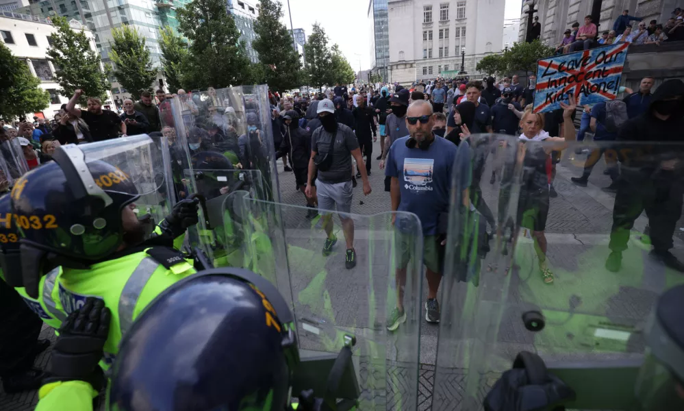 03 August 2024, United Kingdom, Liverpool: People protest in Liverpool, following the stabbing attacks on Monday in Southport, in which three young children were killed. Photo: James Speakman/PA Wire/dpa