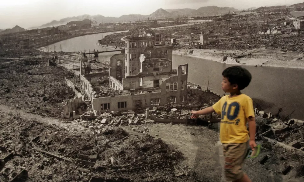 A boy looks at a huge photograph showing Hiroshima city after the 1945 atomic bombing, at the Hiroshima Peace Memorial Museum, Japan August 6, 2007. Japan marked the 62nd anniversary of Hiroshima's atomic bombing with a solemn ceremony on Monday as the city's mayor criticised the United States for refusing to give up its nuclear weapons programme. REUTERS/Toru Hanai (JAPAN)