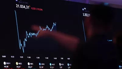 A person points to an electronic board displaying information of recent fluctuations of market indices at the B3 Stock Exchange in Sao Paulo, Brazil August 5, 2024. REUTERS/Carla Carniel