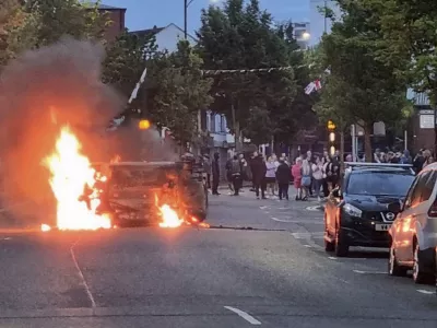 A vehicle is set alight in Belfast, Northern Ireland, following an anti-Islamic protest outside Belfast City Hall on Saturday, Aug. 3, 2024. (David Young/PA via AP)