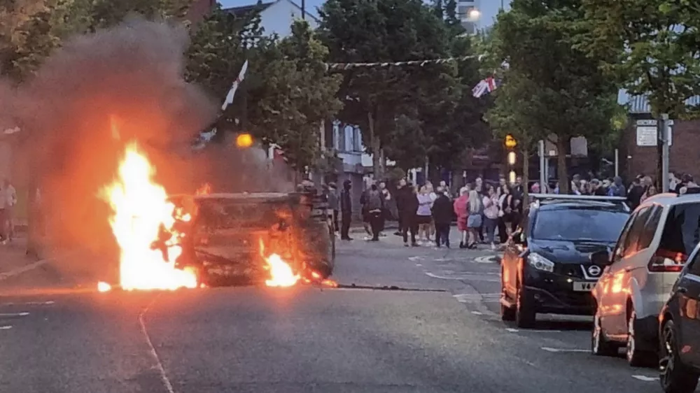 A vehicle is set alight in Belfast, Northern Ireland, following an anti-Islamic protest outside Belfast City Hall on Saturday, Aug. 3, 2024. (David Young/PA via AP)