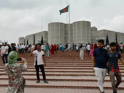 People take pictures in front of the parliament building, a day after the resignation of Bangladeshi Prime Minister Sheikh Hasina, in Dhaka, Bangladesh, August 6, 2024. REUTERS/Mohammad Ponir Hossain