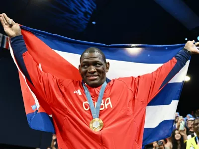 Paris 2024 Olympics - Wrestling - Men's Greco-Roman 130kg Victory Ceremony - Champ-de-Mars Arena, Paris, France - August 06, 2024. Gold medallist Mijain Lopez Nunez of Cuba celebrates during the ceremony. REUTERS/Arlette Bashizi