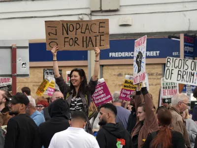 Counter protesters gather ahead of an anti-immigration protest in Birmingham, England, Wednesday, Aug., 7, 2024. (PA via AP)