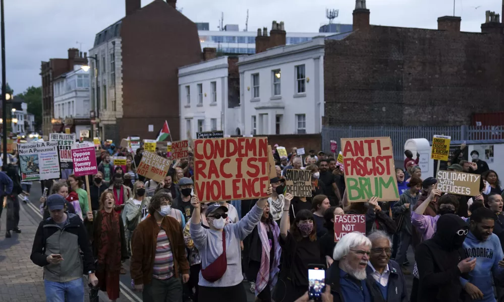 Counter protestors gather in Birmingham, England, Wednesday, Aug. 7, 2024 ahead of anti-immigration groups planning to target dozens of locations throughout the country following a week of rioting fueled by misinformation over a stabbing attack against young girls. (PA via AP)