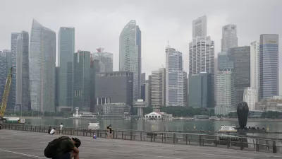 FILE - A man takes a nap as the central business district is shrouded by haze in Singapore, on Sept. 23, 2019. Singapore executed a man Wednesday, July 26, 2023, for drug trafficking and is set to hang a woman Friday — the first in 19 years — prompting renewed calls for a halt to capital punishment. (AP Photo/Vincent Thian, File)