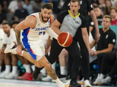 Isaia Cordinier (8), of France drives to the basket against Germany during a men's semifinals basketball game at Bercy Arena at the 2024 Summer Olympics, Thursday, Aug. 8, 2024, in Paris, France. (AP Photo/Mark J. Terrill)