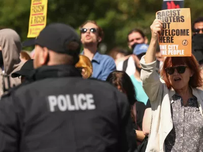 Protesters hold signs at an anti-racism protest in Liverpool, Britain August 10, 2024. REUTERS/Yves Herman